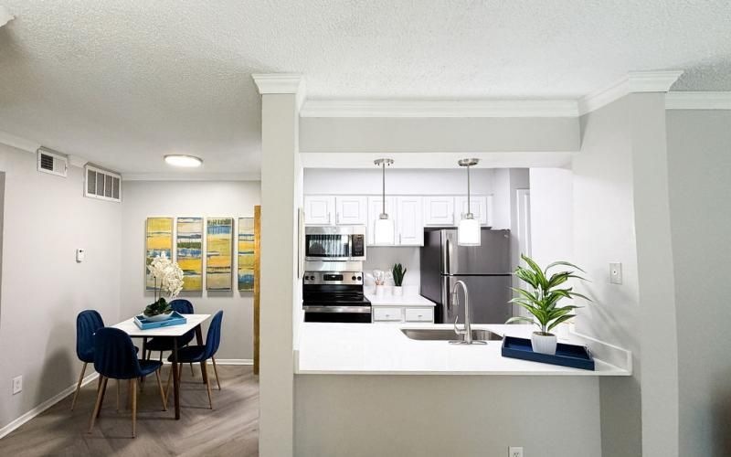 a kitchen with a table and chairs