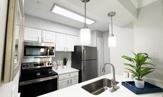 a kitchen with white cabinets