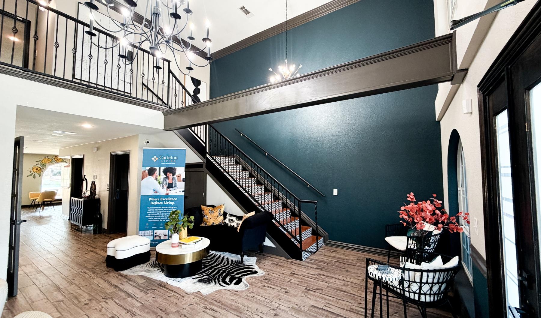 a room with a staircase and chairs