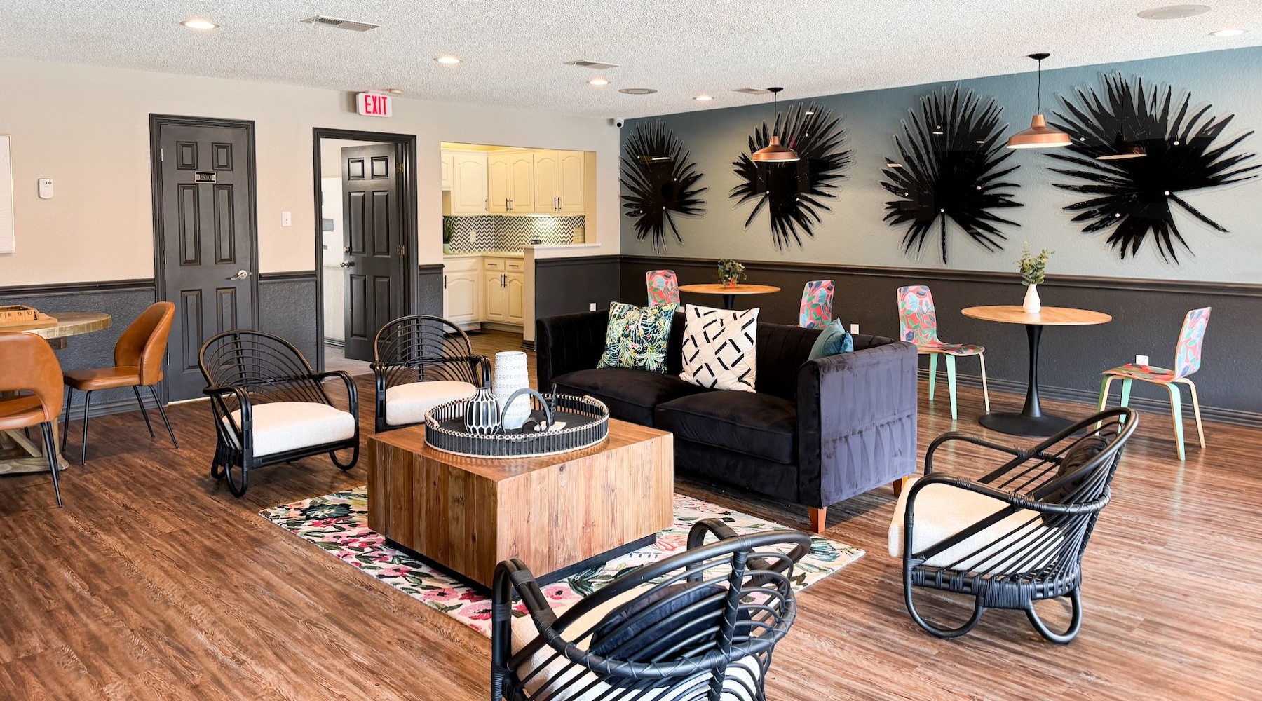 a clubroom with a couch, tables and chairs